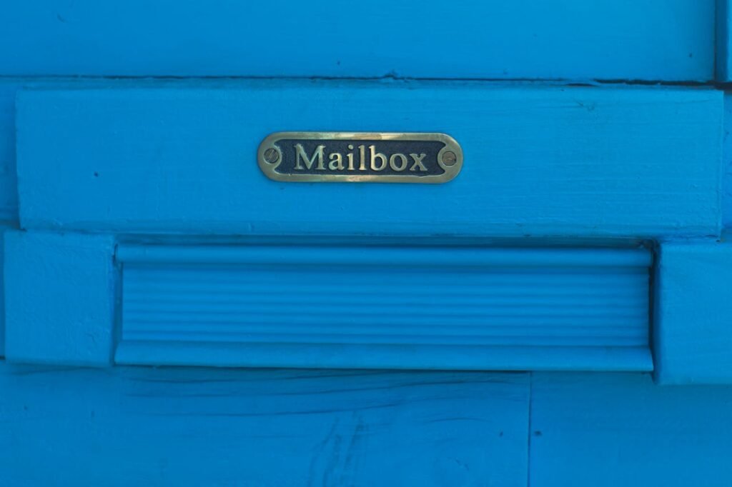 Close-up of a vibrant blue mailbox with decorative metal accents.